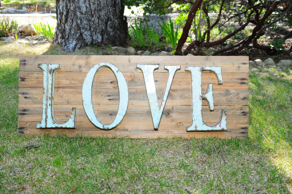 Metal Love sign on rustic wood stand, 15"X40" $25
